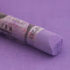  A close-up of a purple Sennelier extra soft pastel on the same coloured background, with the colour information printed on the paper wrap.