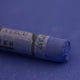  A close-up of a blue Sennelier extra soft pastel on the same coloured background, with the colour information printed on the paper wrap.