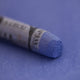  A close-up of a blue Sennelier extra soft pastel on the same coloured background, with the colour information printed on the paper wrap.