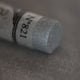 A close-up of an iridescent silver Sennelier extra soft pastel. on the same coloured background, with the colour information printed on the paper wrap.