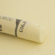 A close-up of a pale yellow Sennelier extra soft pastel. on the same coloured background, with the colour information printed on the paper wrap.