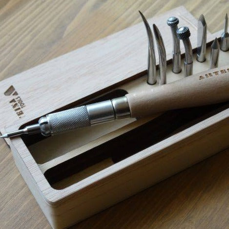 A set of Arteina engraving tools with beech wood handles and carbon steel tips, displayed in a wooden box.