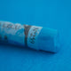 A close-up of a Sennelier large extra soft pastel on a blue background.