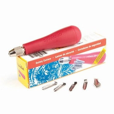The Speedball Zip Cutter packaging is show  next to the array of blades contained in the kit with a red handle on top.
