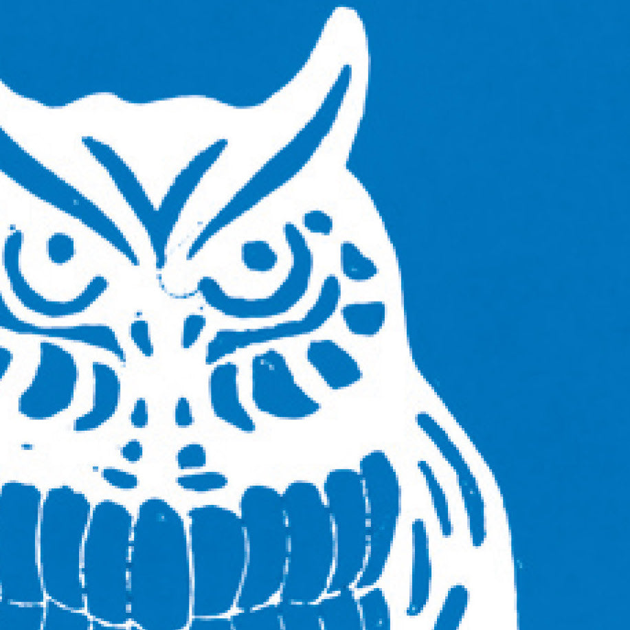 A printed linocut of an owl in blue ink with the outline of the owl appearing in white.