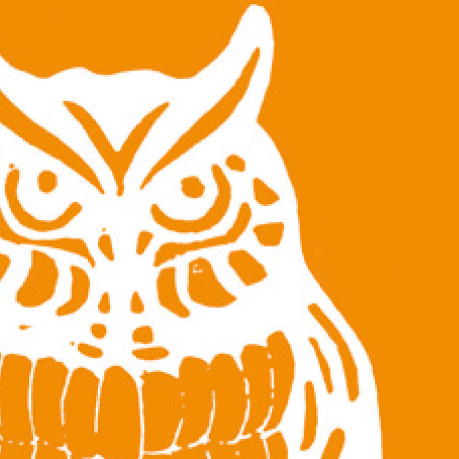 A printed linocut of an owl in yellow ink with the outline of the owl appearing in white.